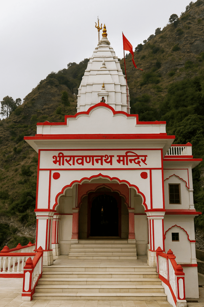 "Bhairavnath Mandir near Vaishno Devi, a white temple with red borders, set on a hilltop with stairs leading to the entrance and a golden kalash atop the shikhara."